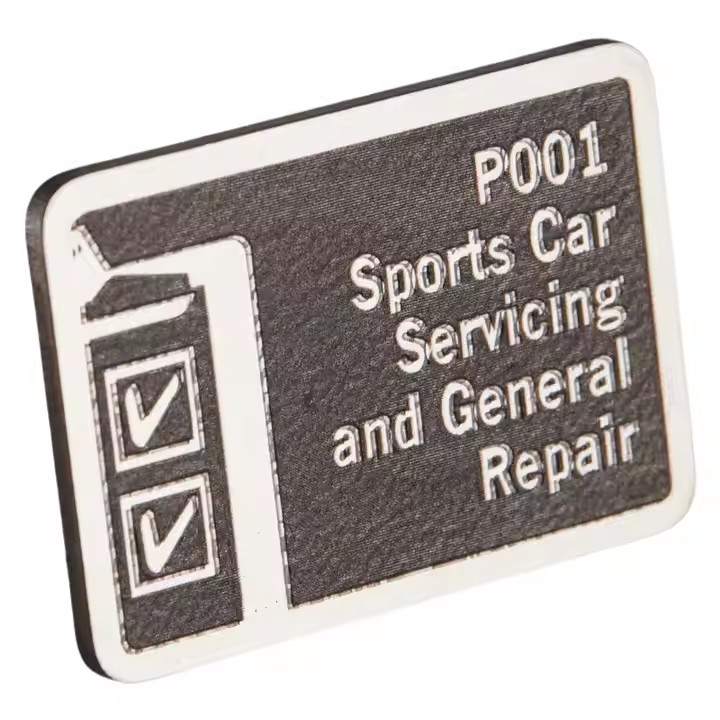 Embossed stainless steel branding label with raised logo design