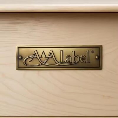Custom brass label for branding and furniture decoration attached to wooden surface
