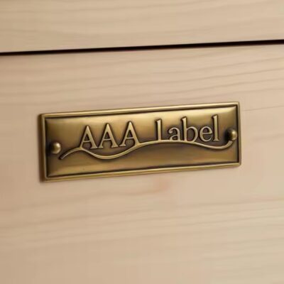 Custom brass label for branding and furniture decoration attached to wooden surface