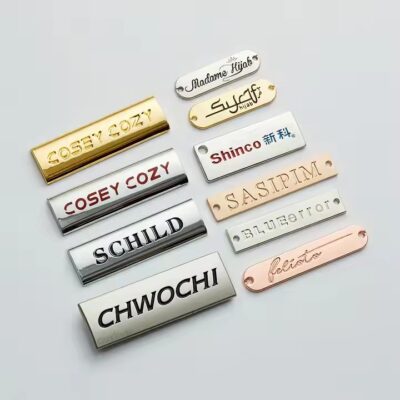 Custom brass label attached to a luxury handbag