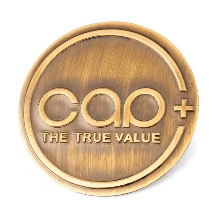 Custom embossed brass label attached to wooden furniture surface