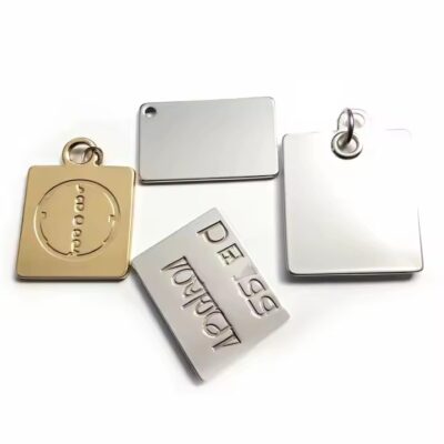 Custom metal logo clothing label attached to fabric