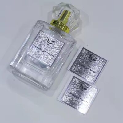 High-quality embossed metal label on perfume bottle