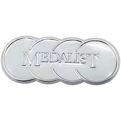 Decorative embossed metal label with intricate design on metal surface