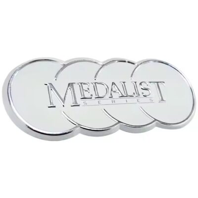 Decorative embossed metal label with intricate design on metal surface