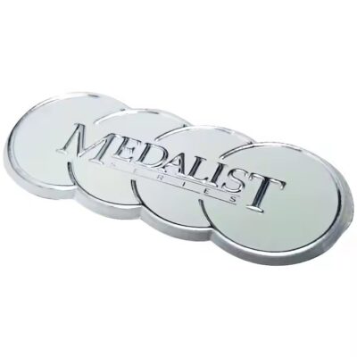 Decorative embossed metal label with intricate design on metal surface