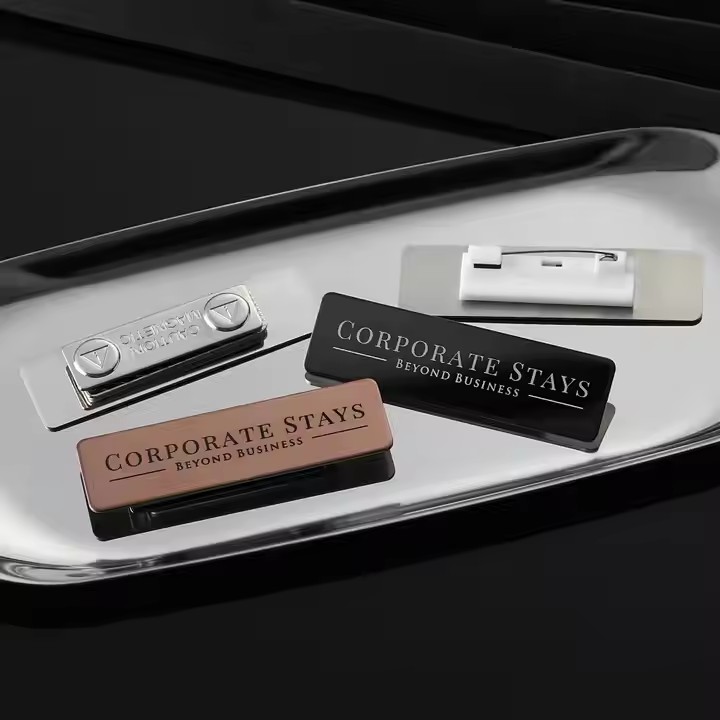 Custom stainless steel name badge with engraved logo and employee name