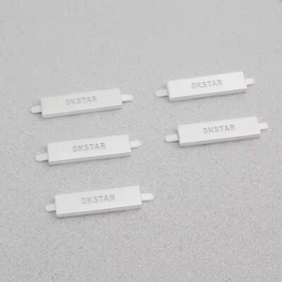 Custom 3D electroplated metal label with laser engraving attached to a fashion handbag