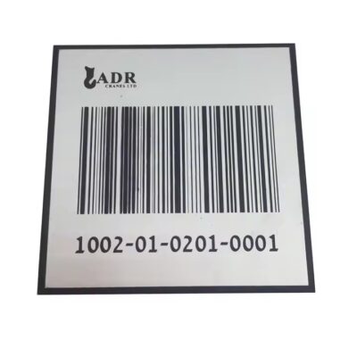 Weatherproof metal barcode label attached to a garden tree, ideal for plant tracking and identification