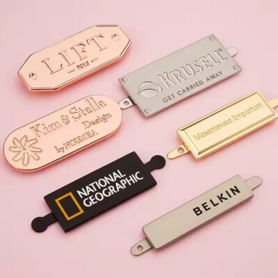 High-quality laser engraved metal tag with logo on a luxury handbag