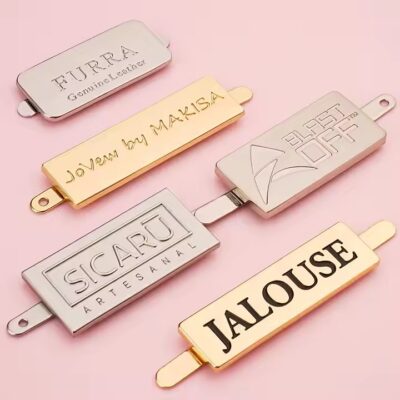 High-quality laser engraved metal tag with logo on a luxury handbag