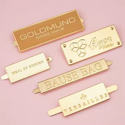 High-quality laser engraved metal tag with logo on a luxury handbag