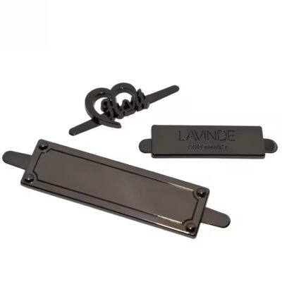 High-quality laser engraved metal tag attached to a luxury handbag
