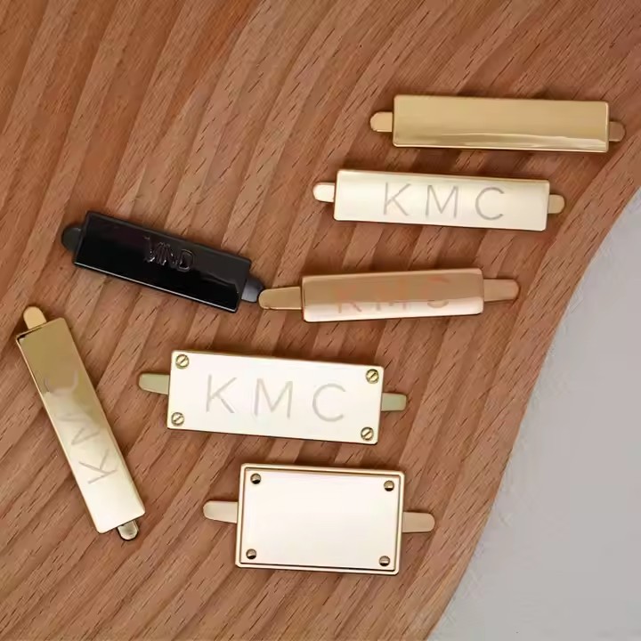 High-quality laser engraved metal tag attached to a luxury handbag