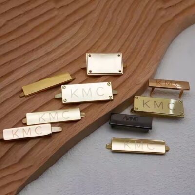 High-quality laser engraved metal tag attached to a luxury handbag