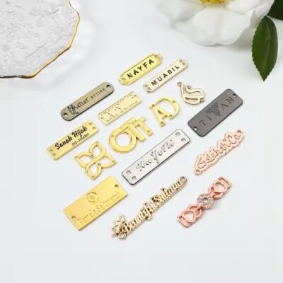 Custom laser engraved metal tag showcasing apparel brand logo on clothing

