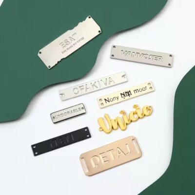 Custom laser engraved metal tag showcasing apparel brand logo on clothing

