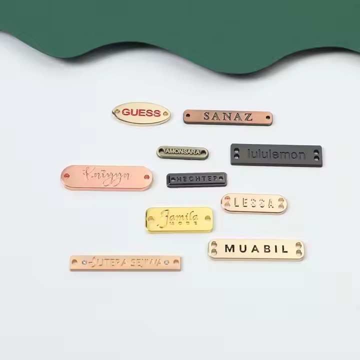 Custom laser engraved metal tag showcasing apparel brand logo on clothing