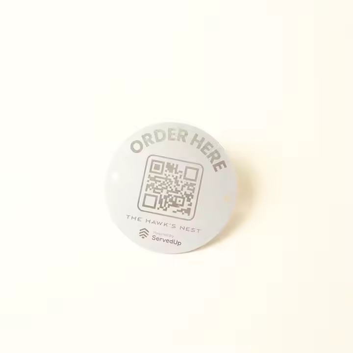 Weatherproof metal QR code label on a tree for plant identification outdoors