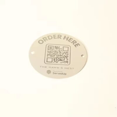 Weatherproof metal QR code label on a tree for plant identification outdoors