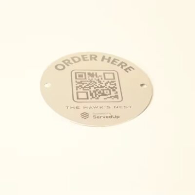 Weatherproof metal QR code label on a tree for plant identification outdoors