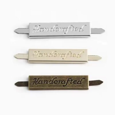 Custom laser engraved metal tag for handbags, clothing, and wallet branding