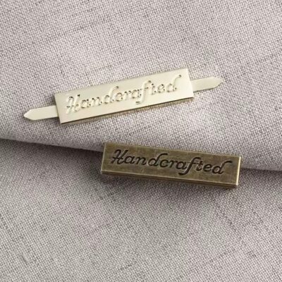 Custom laser engraved metal tag for handbags, clothing, and wallet branding