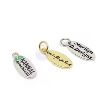 Custom laser engraved metal tag with pre-attached jump ring for product labeling